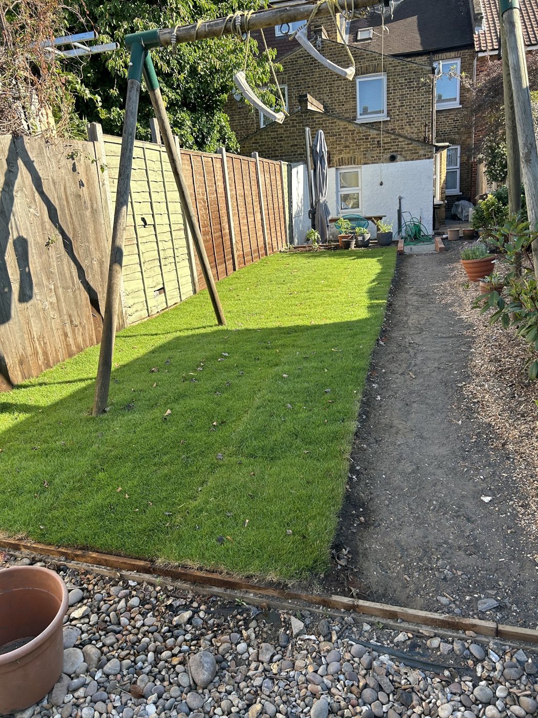Finished lawn with new fence panels and gravel border